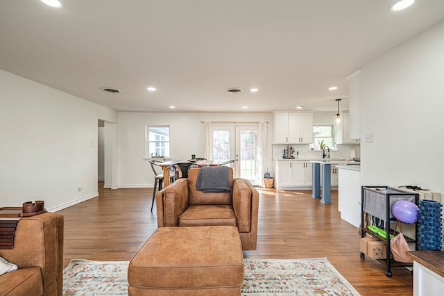 living room featuring light hardwood / wood-style floors and french doors