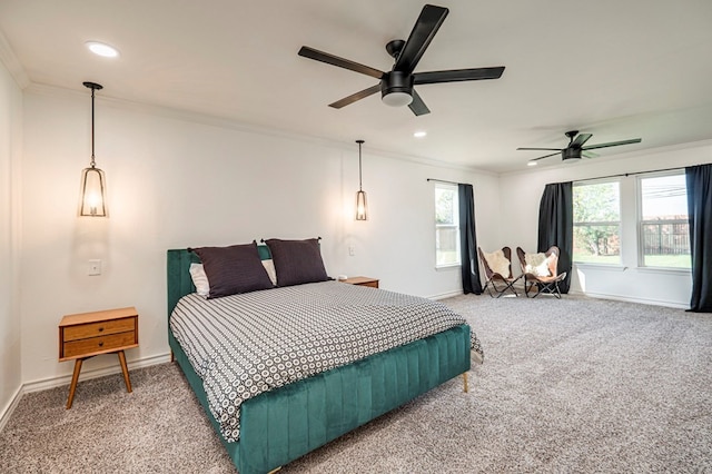 carpeted bedroom with ceiling fan and crown molding