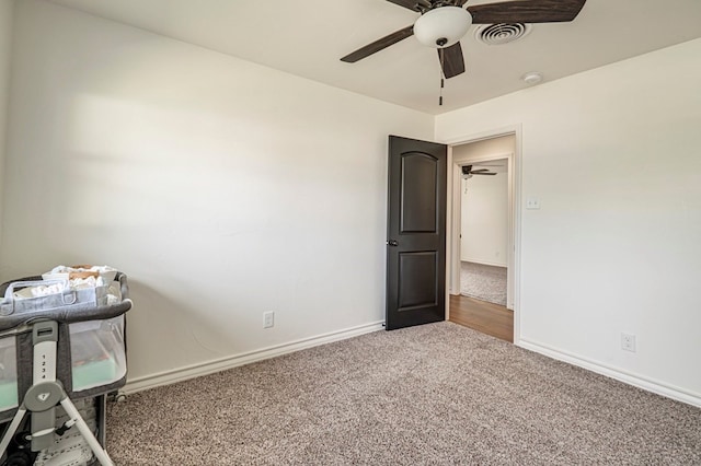 unfurnished bedroom with ceiling fan and carpet flooring