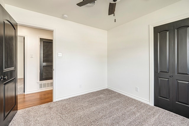 unfurnished bedroom featuring ceiling fan, carpet, and a closet