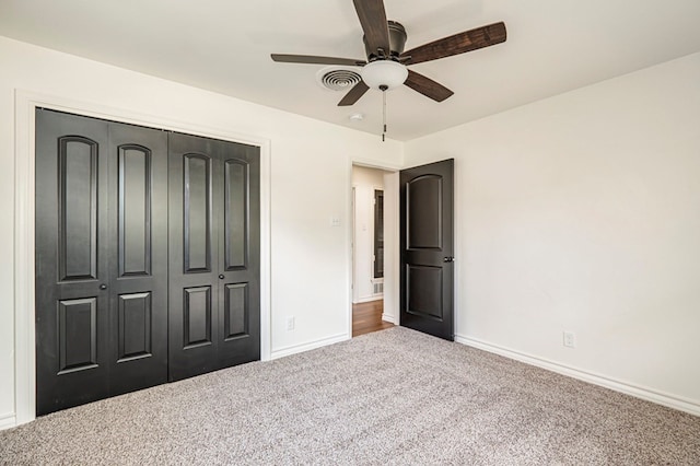 unfurnished bedroom featuring ceiling fan, a closet, and carpet floors