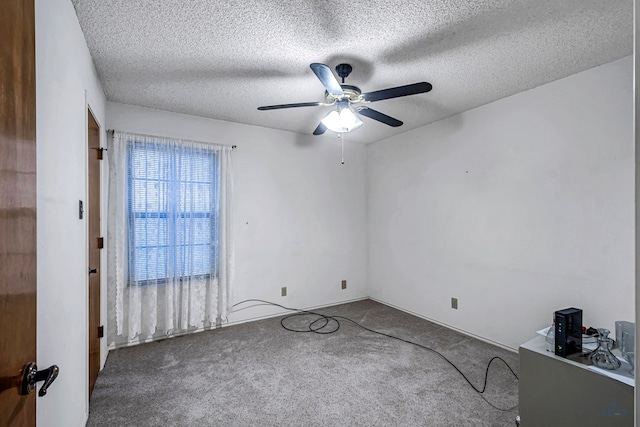 spare room with a textured ceiling, carpet floors, and ceiling fan