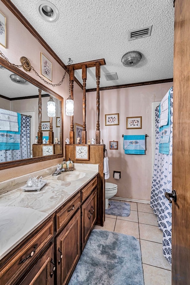 bathroom featuring visible vents, toilet, ornamental molding, tile patterned flooring, and vanity