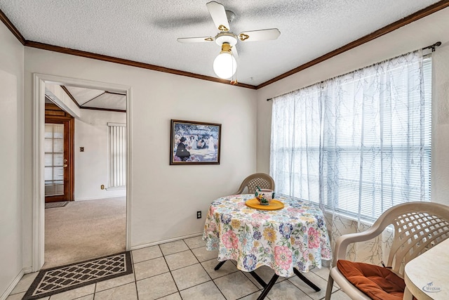 dining room featuring light carpet, a textured ceiling, and crown molding