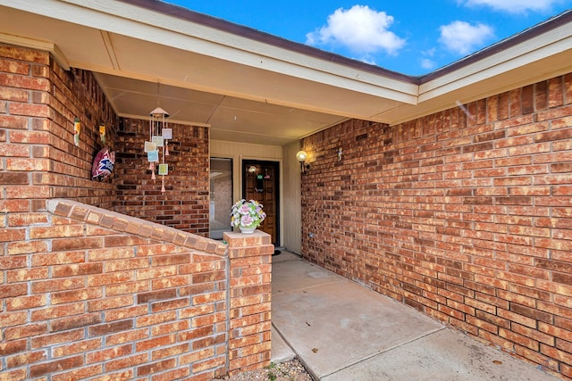 property entrance with brick siding