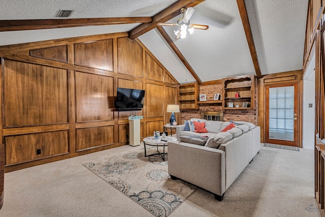 living area with light colored carpet, visible vents, vaulted ceiling with beams, and a textured ceiling