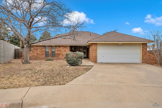 ranch-style house with brick siding, a shingled roof, fence, a garage, and driveway