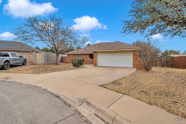 single story home with a garage, fence, concrete driveway, and brick siding