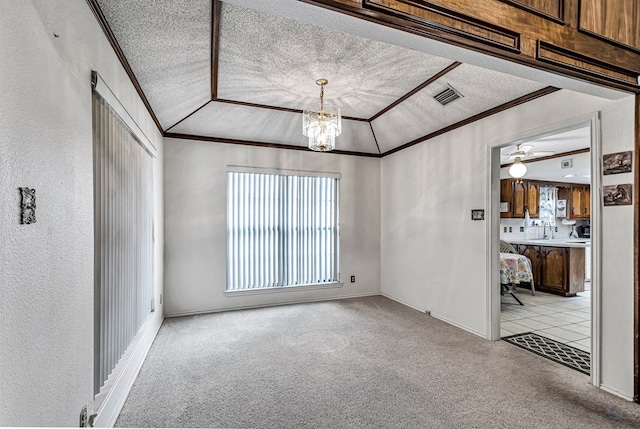 unfurnished room featuring crown molding, a textured ceiling, visible vents, and light colored carpet