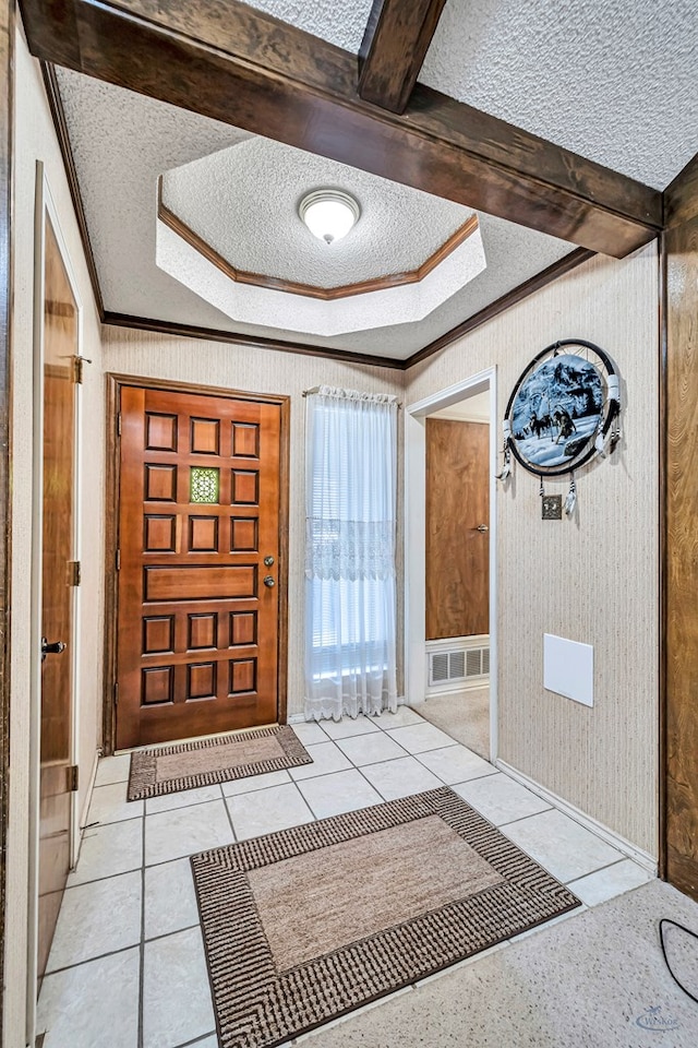 foyer featuring light tile patterned flooring, crown molding, and a textured ceiling