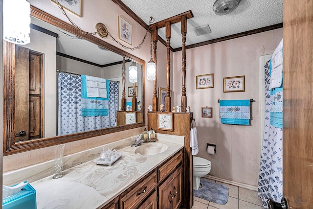 bathroom featuring a textured ceiling, tile patterned flooring, toilet, vanity, and crown molding