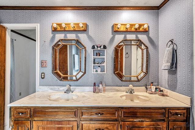 full bath with double vanity, wallpapered walls, and a sink