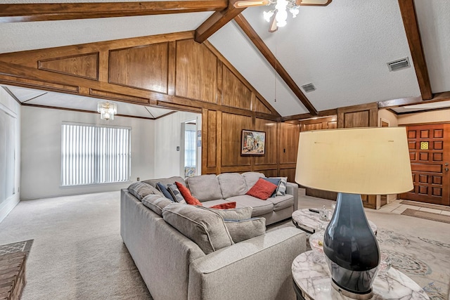 living room featuring high vaulted ceiling, wooden walls, light carpet, visible vents, and beamed ceiling