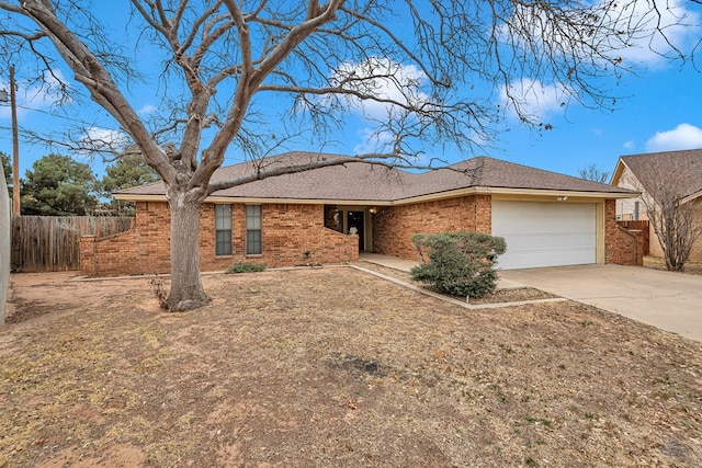 ranch-style home with an attached garage, fence, concrete driveway, and brick siding