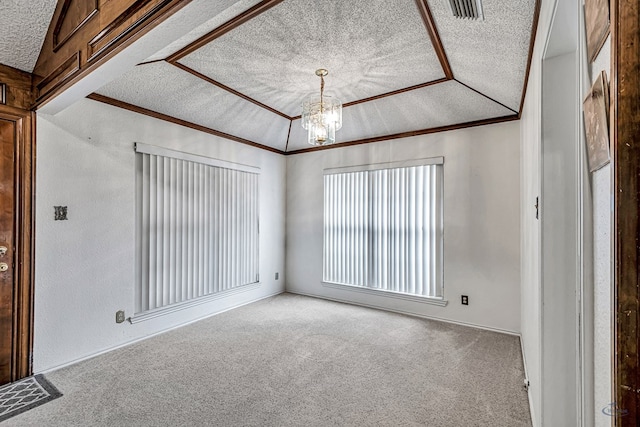 carpeted empty room featuring visible vents, an inviting chandelier, vaulted ceiling, crown molding, and a textured ceiling