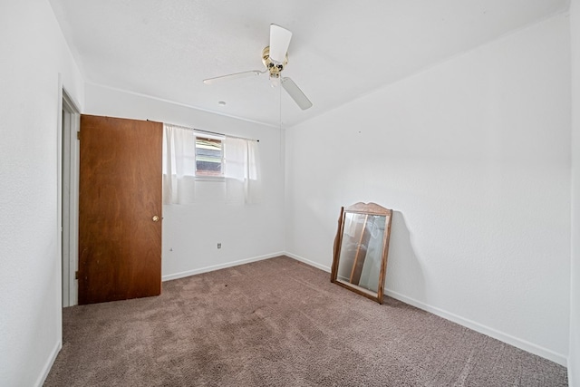 spare room with carpet floors, ceiling fan, and baseboards