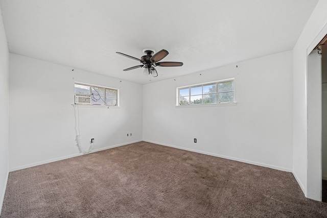 empty room featuring carpet, a healthy amount of sunlight, ceiling fan, and baseboards