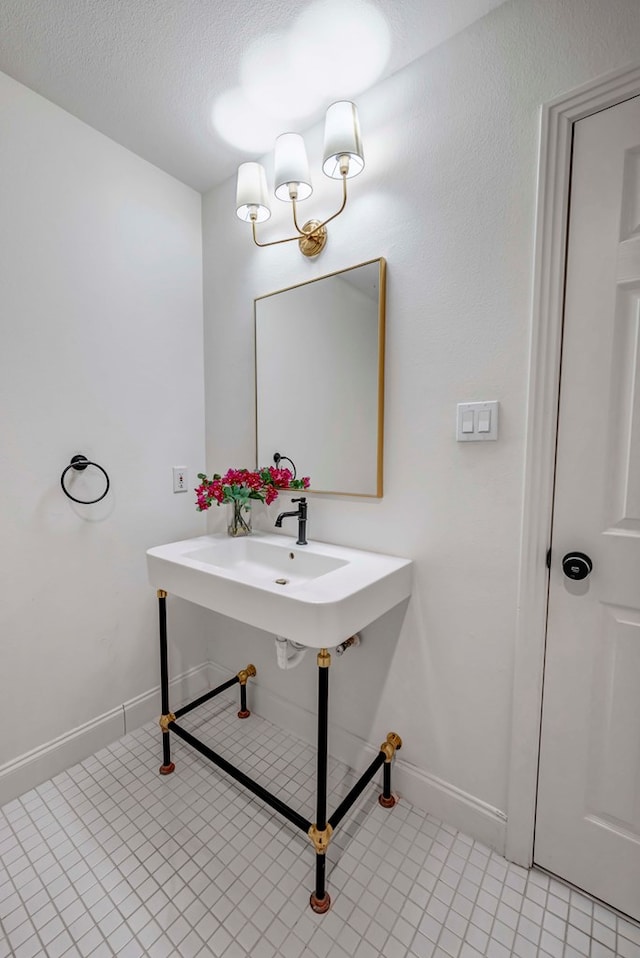 bathroom with tile patterned flooring and a textured ceiling