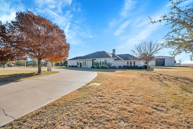 ranch-style home with a front lawn