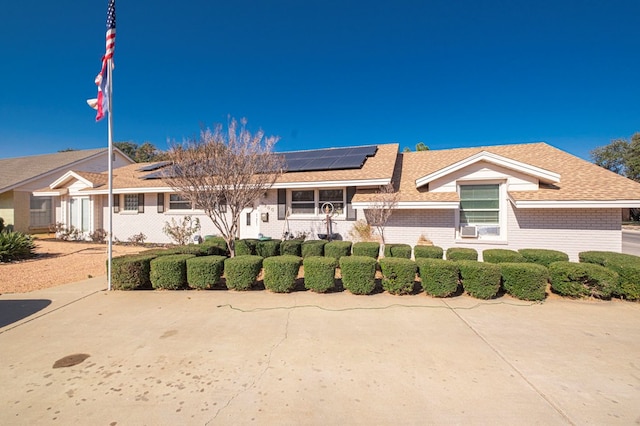 single story home with solar panels