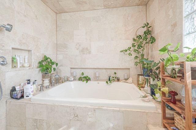 bathroom with tiled bath and tile walls