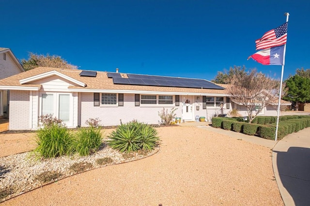 ranch-style house with solar panels