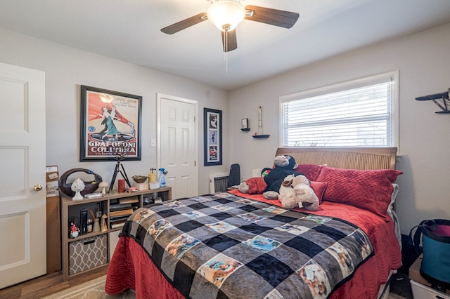 bedroom featuring ceiling fan and radiator