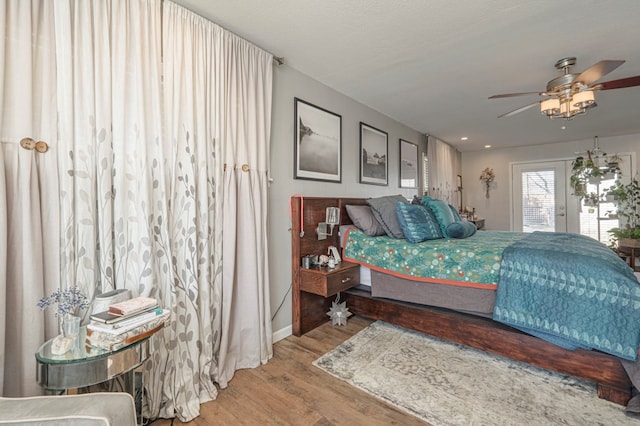 bedroom with ceiling fan and hardwood / wood-style floors