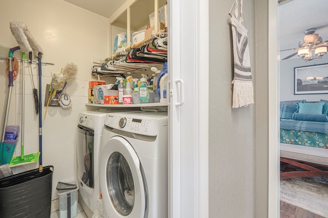 clothes washing area with washer and clothes dryer