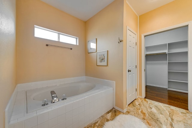 bathroom featuring tiled bath