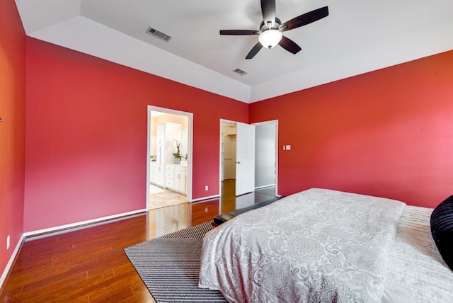 bedroom with wood-type flooring, ensuite bath, and ceiling fan