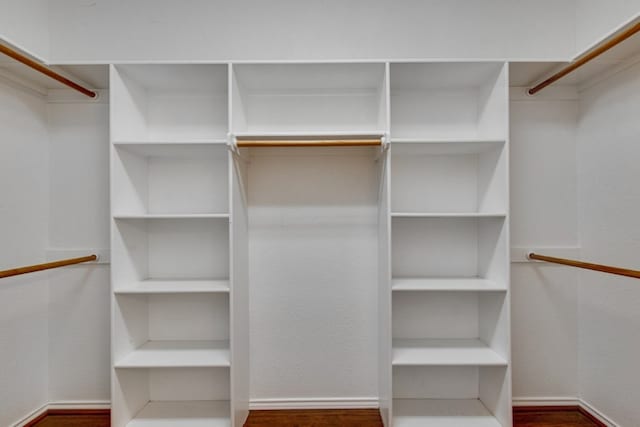 spacious closet with dark hardwood / wood-style floors