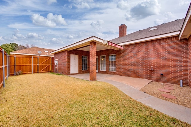 back of house featuring a patio and a lawn