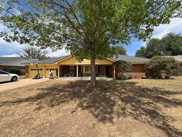 2408 Camarie Ave, Midland, TX 79705 - ranch-style home featuring a porch, brick siding, an attached garage, and concrete driveway