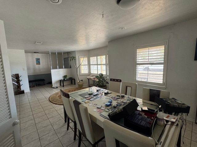 2408 Camarie Ave, Midland, TX 79705 - dining room featuring light tile patterned flooring and a textured ceiling