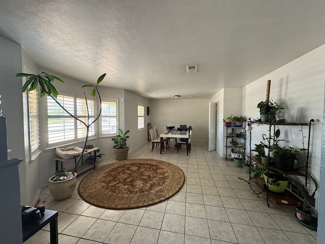 2408 Camarie Ave, Midland, TX 79705 - dining area featuring light tile patterned floors and a textured ceiling