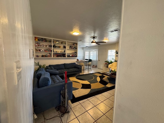 2408 Camarie Ave, Midland, TX 79705 - living area with light tile patterned flooring, a textured ceiling, and a ceiling fan