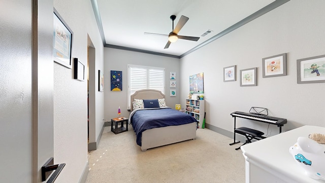 bedroom featuring light colored carpet, crown molding, baseboards, and a ceiling fan