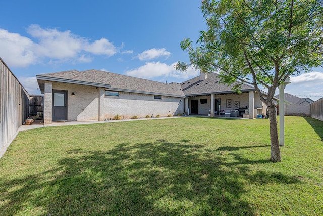 rear view of house with a patio and brick siding