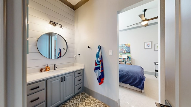 bathroom with ceiling fan, vanity, and baseboards