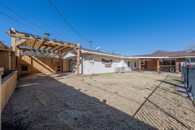 back of property with a patio area, a fenced backyard, and a pergola