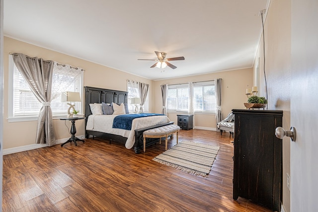 bedroom featuring a ceiling fan, baseboards, and wood finished floors