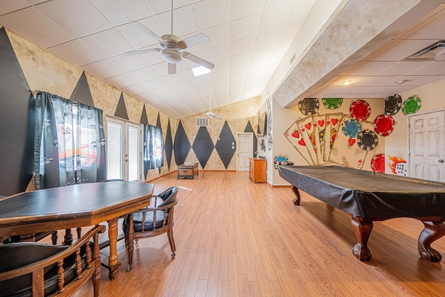 rec room with light wood finished floors, wallpapered walls, lofted ceiling, ceiling fan, and a paneled ceiling