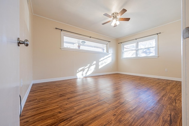 spare room featuring baseboards, ceiling fan, wood finished floors, and crown molding