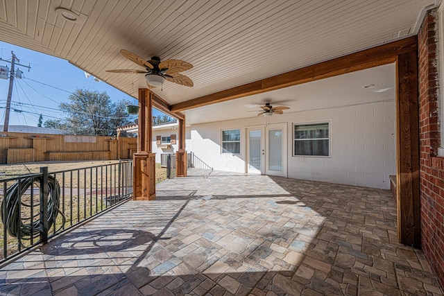 view of patio featuring a ceiling fan and fence