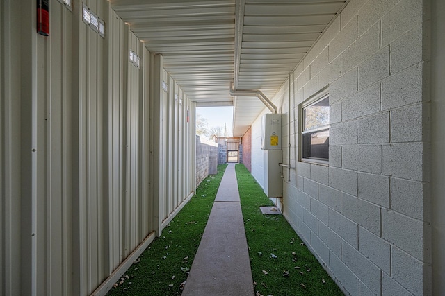 interior space with concrete block siding and fence