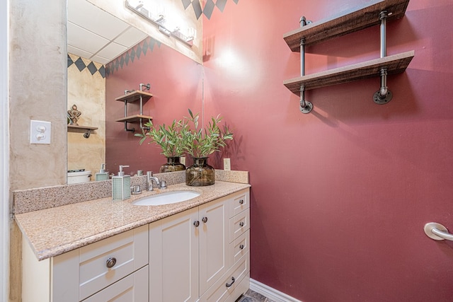 bathroom with vanity and baseboards