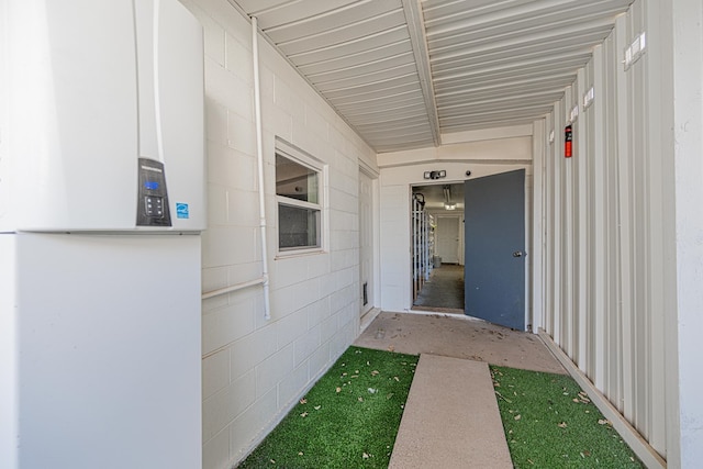 entrance to property featuring concrete block siding