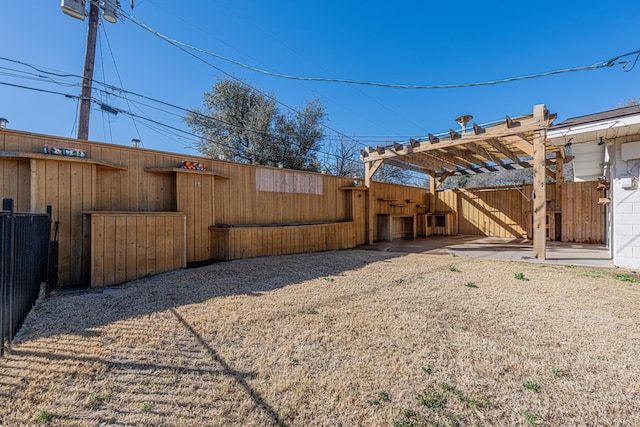 view of yard with fence and a pergola