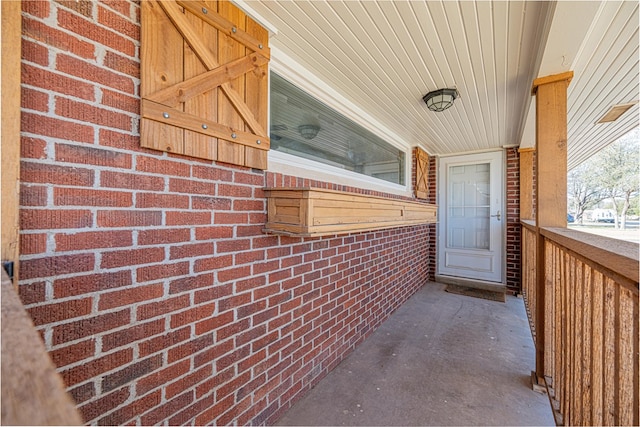 view of exterior entry with brick siding